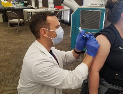 Doctor Brian J. Morini of Advent Health giving free COVID vaccine shots at Orlando Airport